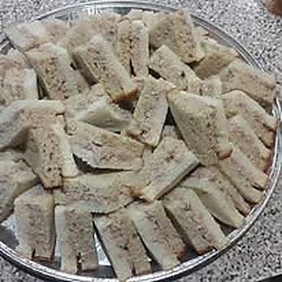 A platter of cut finger sandwiches